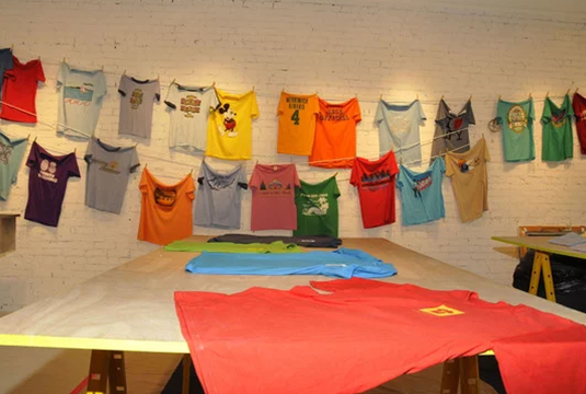 tee shirts hung on wall