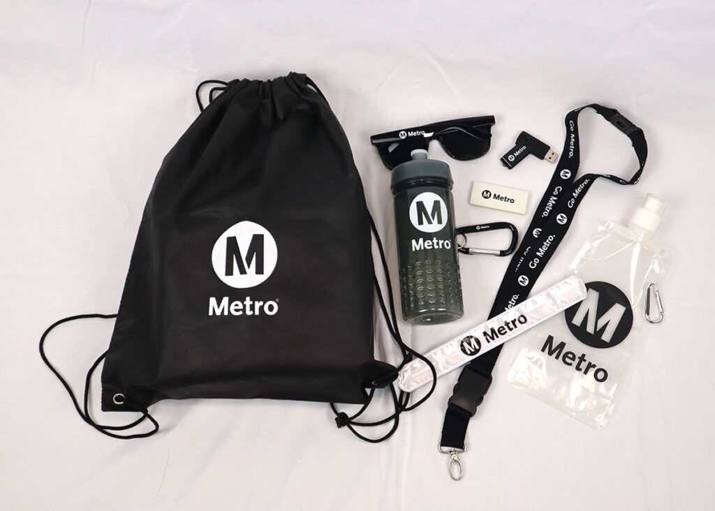drawstring gift set with water bottle, sunglasses, lanyard, usb drive and eraser